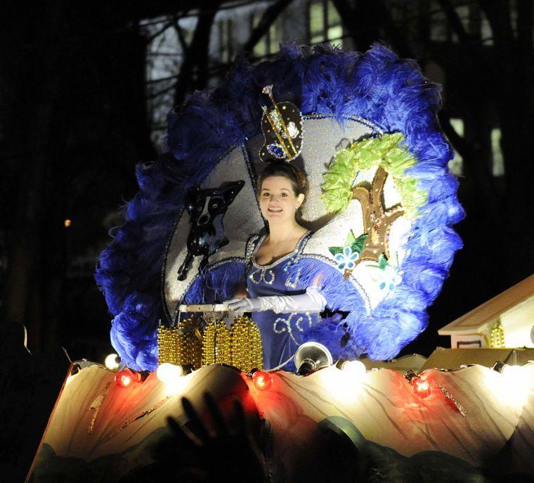 Krewe of Orion member rides in the parade Saturday night, Feb. 22, 2014.