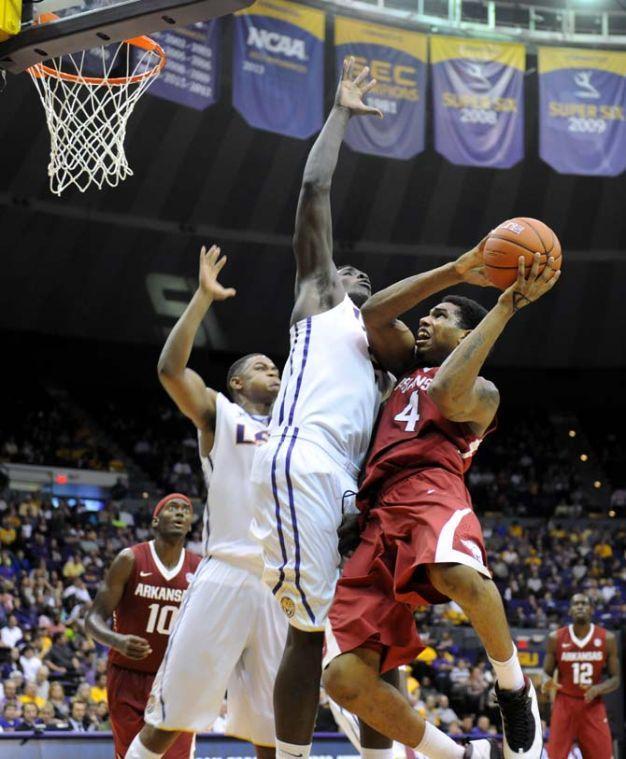 LSU junior forward Johnny O'Bryant III (2) blocks Arkansas senior forward Coty Clarke (4) Feb. 1, 2014 during the Tigers' 88-74 victory against the Razorbacks at the PMAC.