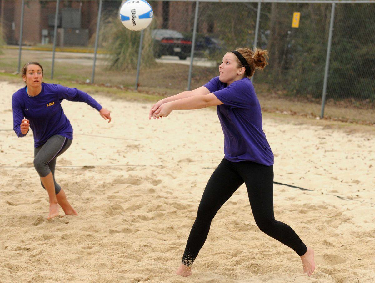 LSU freshman Emma Hiller (right) attempts to set the ball for senior Meghan Mannari (left) Friday, Feb. 7, 2013 during practice at Mango's Beach Volleyball.