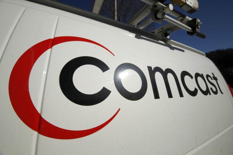 FILE - This Feb. 11, 2011 file photo shows the Comcast logo on one of the company's vehicles, in Pittsburgh. Comcast has agreed to buy Time Warner Cable for $45.2 billion in stock, or $158.82 per share, in a deal that would combine the top two cable TV companies in the nation, according to a person familiar with the matter who spoke on condition of anonymity because it had not been announced formally. An announcement is set for Thursday morning, Feb. 13, 2014, the person said. (AP Photo/Gene J. Puskar, File)