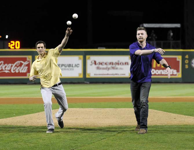 Former LSU pitcher Chris Cotton (left) and former outfielder Raph Rhymes (right) throw the first pitch of Friday's 2-0 win against UNO in Alex Box Stadium.