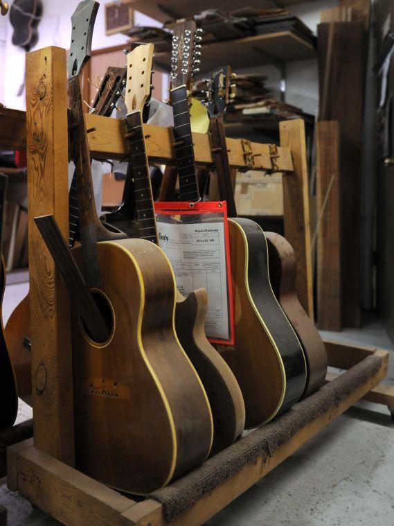 Acoustic guitars await to be repaired Friday, February 7, 2014 at Tim's Guitar Repair and Workshop.