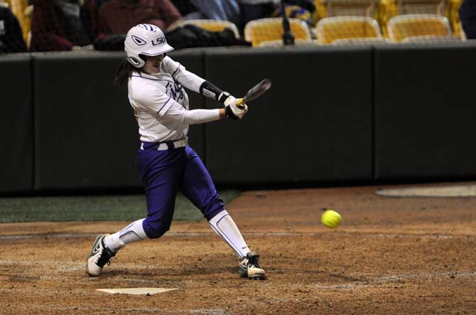 LSU senior infielder Allison Falcon (32) hits a ground ball Saturday, Feb. 8, 2014 during the Tigers' 1-0 win against Oklahoma State in Tiger Park.