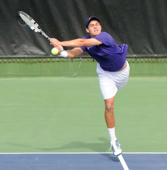 LSU freshman Eric Perez hits a volley Saturday, Feb. 8, 2013 during the Tigers' doubles match at W.T. "Dub" Robinson Stadium.