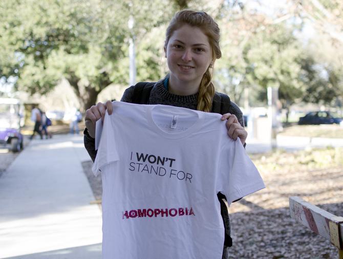 Freshman Errin O'Connor, a Biology major at LSU, holds up her "I Won't Stand For..." shirt stamped with "Homophobia" from USA Characters Unite campaign.