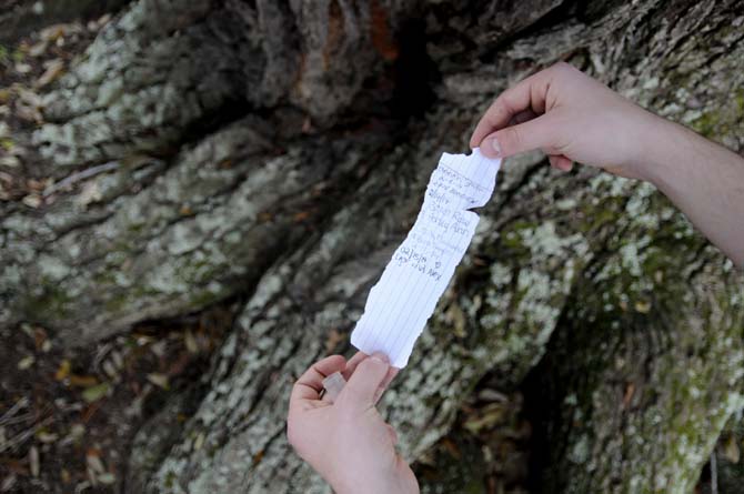 A note is taken out of a cache Tuesday, Feb. 18, 2014 in between the Poultry Science and the Agricultural Engineering buildings.