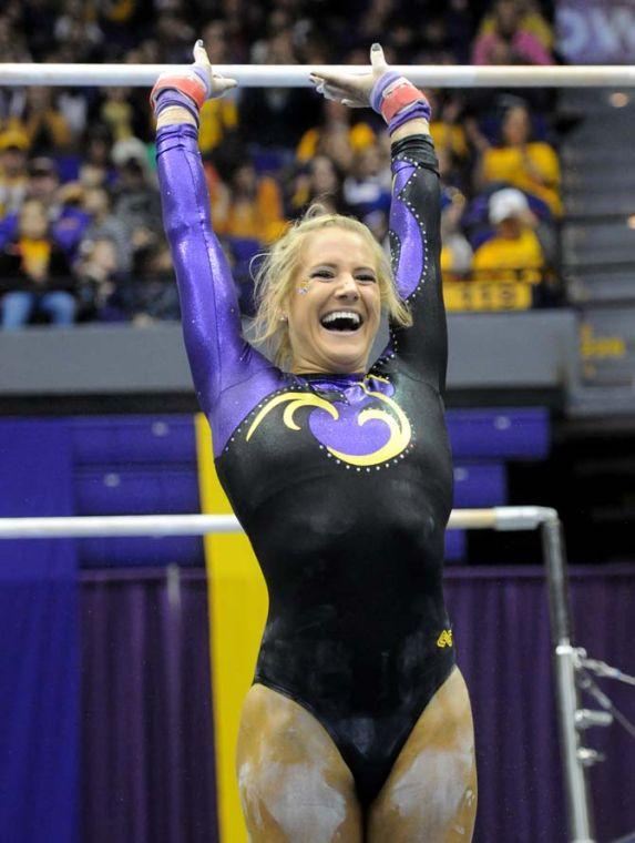 LSU senior all-around gymnast Sarie Morrison smiles while landing after her uneven bar routine Friday, Jan. 31, 2014 during the Tigers' 197.650-196.825 victory against Alabama in the PMAC.