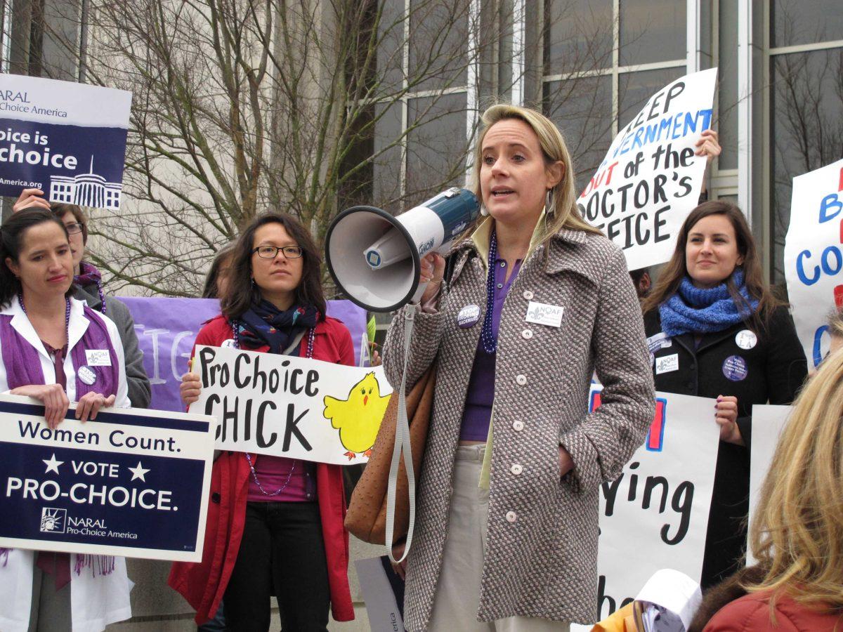 Ellie Schilling, center, a lawyer representing Louisiana abortion clinics, speaks at a protest outside the Department of Health and Hospitals building on Tuesday, Feb. 4, 2013, in Baton Rouge, La. Abortion rights supporters say DHH issued rules that would have shut down all of the state's abortion clinics. The department rescinded the rules this week. (AP Photo/Melinda Deslatte)