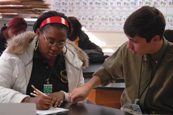 <p>LSU alumnus Hunter Brown helps Taneisha Callegari, Scotlandville Magnet High School junior, with a chemistry problem on Tuesday morning. Brown is a recent college graduate in the Teach for America program.</p>