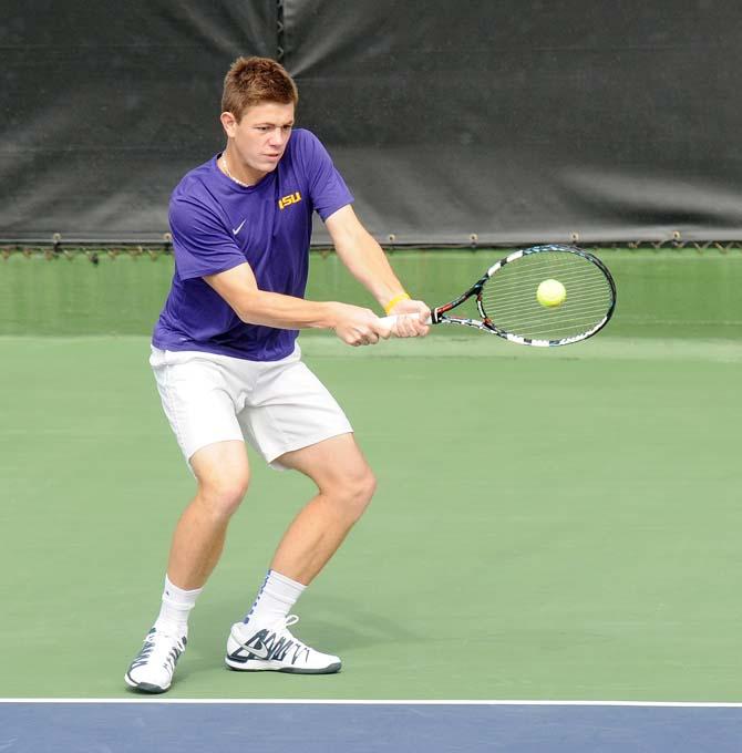 LSU junior Chris Simpson returns a volley Saturday, Feb. 8, 2013 during the Tigers' doubles match at W.T. "Dub" Robinson Stadium.