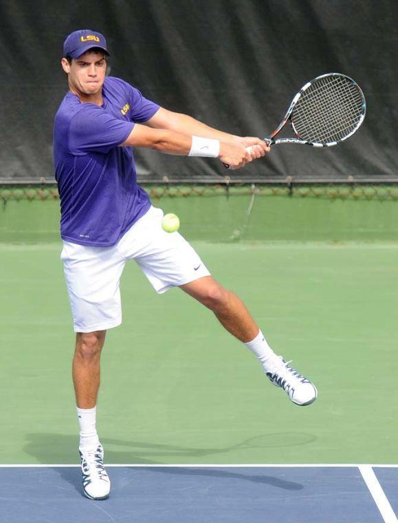 LSU freshman Eric Perez returns a serve Saturday, Feb. 8, 2013 during the Tigers' doubles match at W.T. "Dub" Robinson Stadium.