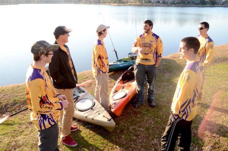 The LSU Kayak Fishing Club stands next to their Kayaks at Milford Wampold Memorial Park.