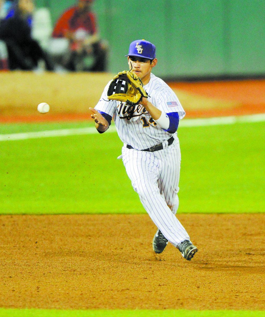 LSU senior infielder Christian Ibarra (14) fields a ball Tuesday, Feb. 25, 2014 during the Tigers' 1-4, five-inning loss to ULL in Alex Box Stadium.