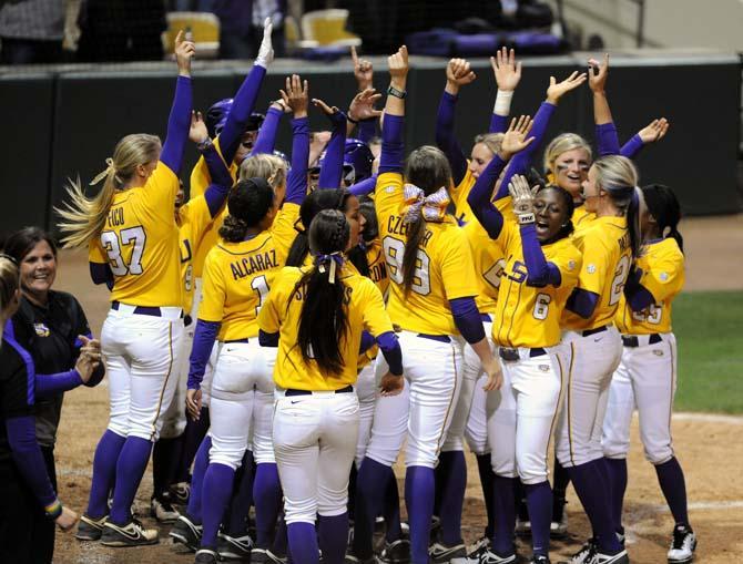 The team celebrates after junior utility player Allison Falcon made a homerun on Thursday, April 25, 2013 during the LSU vs. Alabama softball game in Tiger Park.