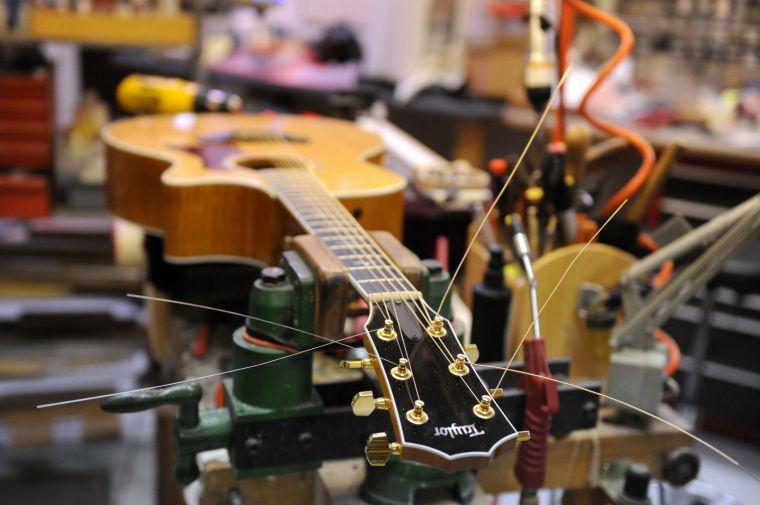 A Taylor acoustic guitar lays on the shop table Friday afternoon Feb. 7, 2014 at Tim's Guitar Repair and Workshop.