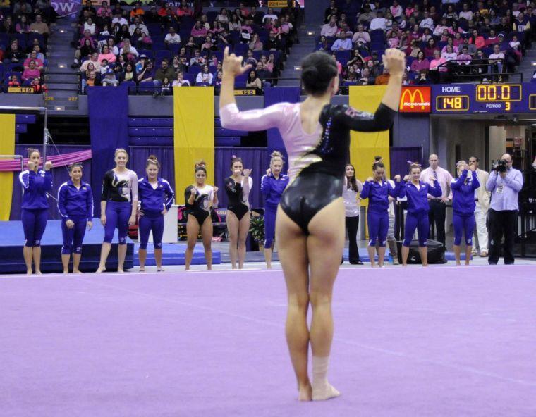 All-around gymnast Rheagan Courville strikes a pose during her floor routine Friday, March 7, 2014 during the Tigers' 197.500 - 195.525 victory against NC State in the Pete Maravich Assembly Center.