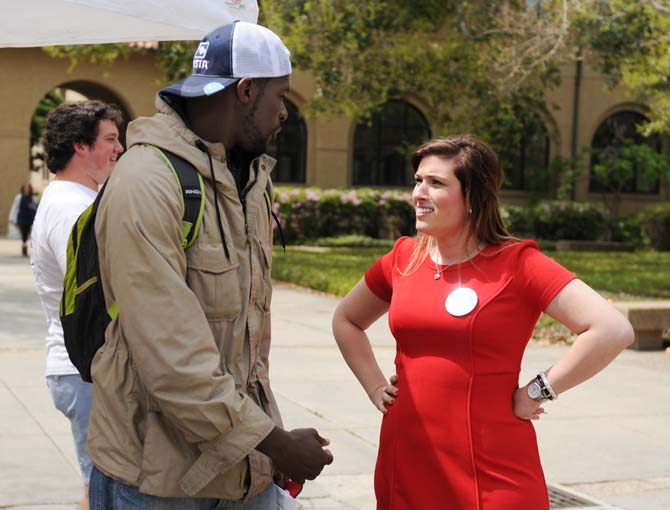 Vice presidential candidate Ashleigh Pichon talks to a student about the Experience LSU ticket Monday, March 24, 2014 on Student Government election day.