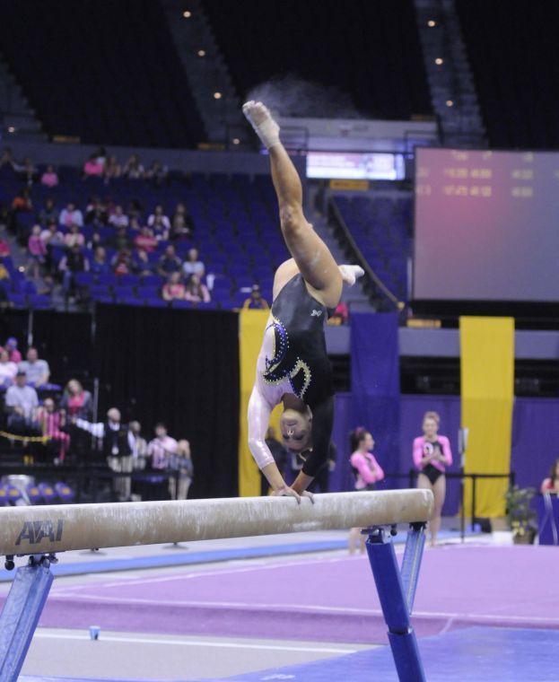 All-around gymnast Sydney Ewing flips during her beam routine Friday, March 7, 2014 during the Tigers' 197.500 - 195.525 victory against NC State in the Pete Maravich Assembly Center.