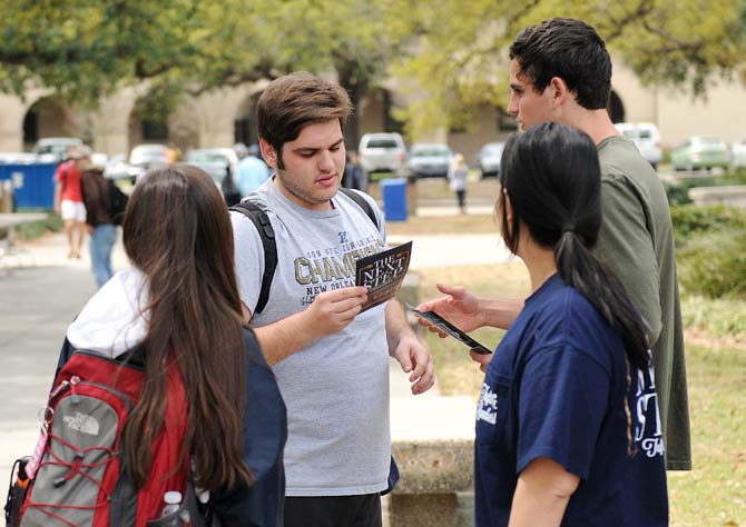 Campaign volunteers hand out flyers to students to promote The Next Step ticket Monday, March 24, 2014 on Student Government election day.