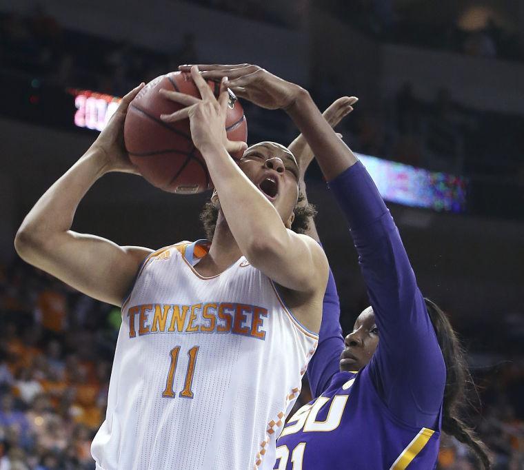 Tennessee forward Cierra Burdick (11) has her shot blocked by LSU forward Shanece McKinney (21) during the first half in an NCAA college basketball game in the quarterfinals of the Southeastern Conference women's tournament, Friday, March 7, 2014, in Duluth, Ga. (AP Photo/Jason Getz)