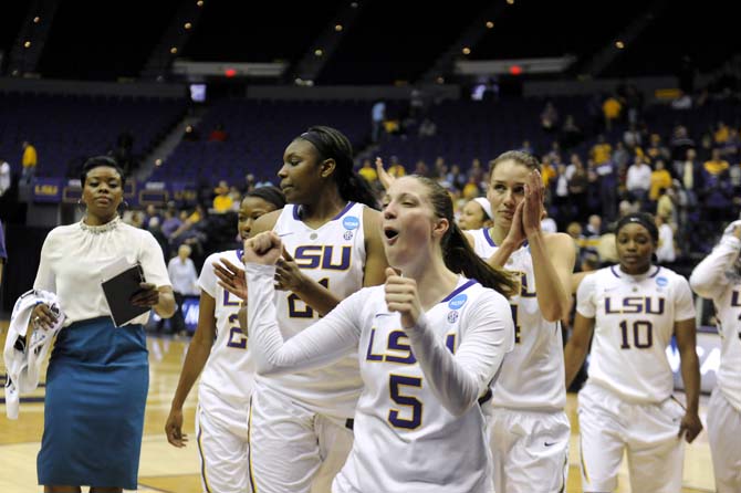 LSU senior guard Jeanne Kenney (5) celebrates with her team Sunday, March 23, 2014, after the Tigers' 98-78 victory against Georgia Tech in the PMAC.