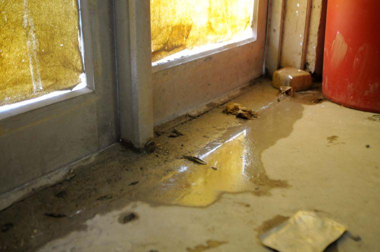 Water seeps into an entryway of the Studio Arts Building.