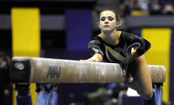 LSU freshman Ashleigh Gnat starts on the beam Friday, March 14, 2014 during the Lady Tigers' 197.800-195.000 victory against Kentucky in the PMAC.