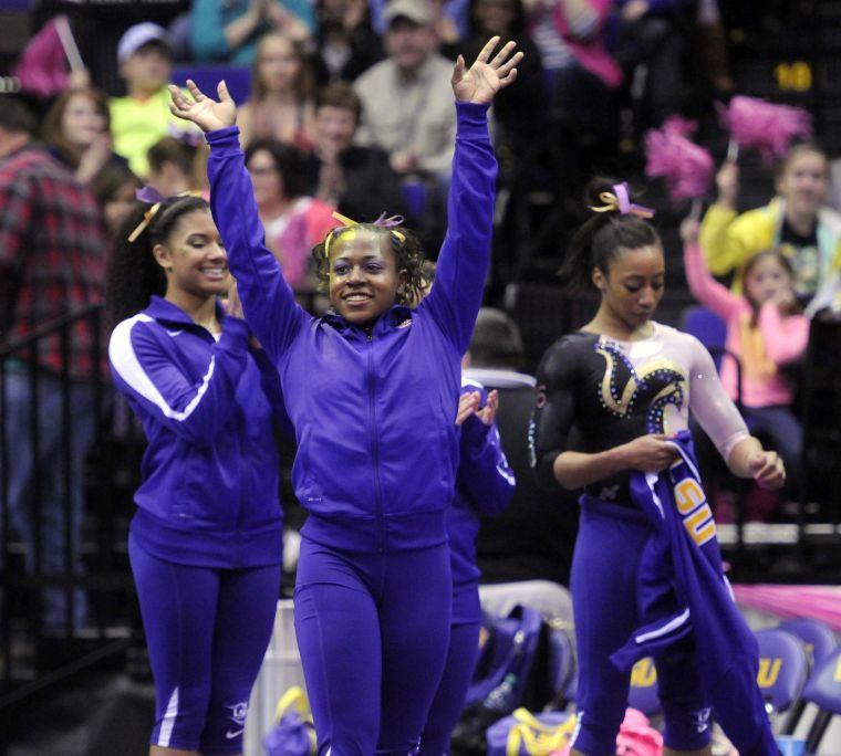 All-around gymnast Lloimincia Hall celebrates after receiving her score Friday, March 7, 2014 during the Tigers' 197.500 - 195.525 victory against NC State in the Pete Maravich Assembly Center.