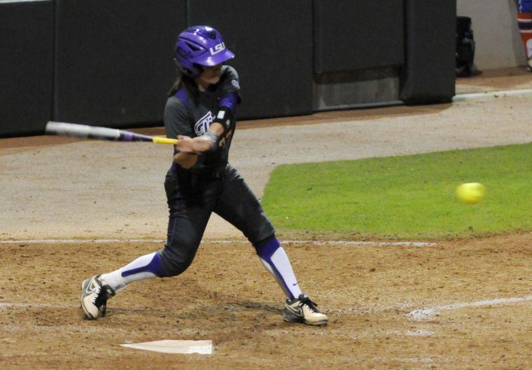 LSU senior infielder Allison Falcon (32) slams the ball during the Lady Tigers' 3-2 victory against the Gators on March 15, 2014 at Tiger Park.