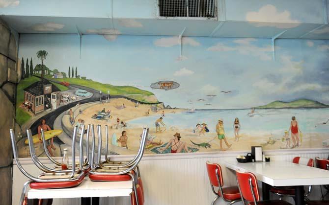A mural painted by Juliet Lockwood was painted on the left wall of Louie's Café in 2003 and has been retouched three times since then.