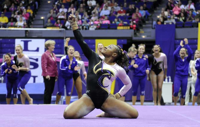 LSU junior all-around gymnast Lloimincia Hall ends her floor routine with a pose Friday, March 7, 2014 during the Tigers' 197.500-195.525 victory against NC State in the PMAC.