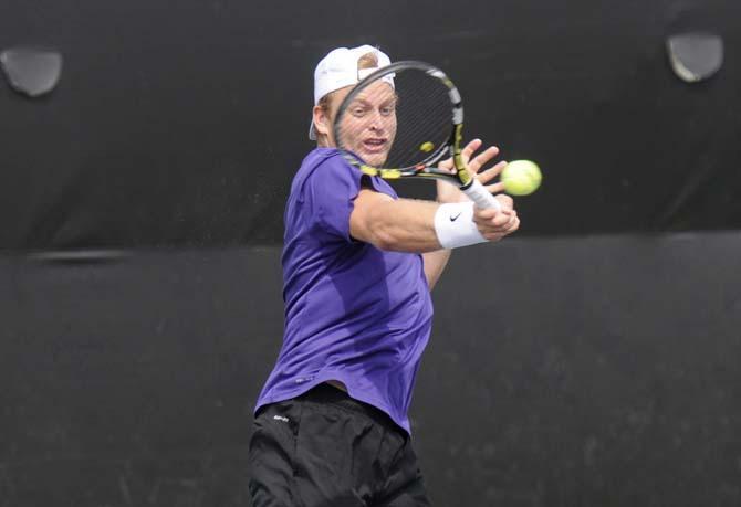 LSU sophomore Andrew Korinek returns a serve Friday, March 7, 2014 during a doubles match against Alabama in W.T. "Dub" Robinson Stadium.