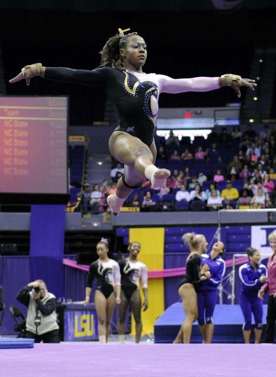 LSU junior all-around gymnast Lloimincia Hall leaps during her floor routine Friday, March 7, 2014 during the Tigers' 197.500-195.525 victory against NC State in the PMAC.