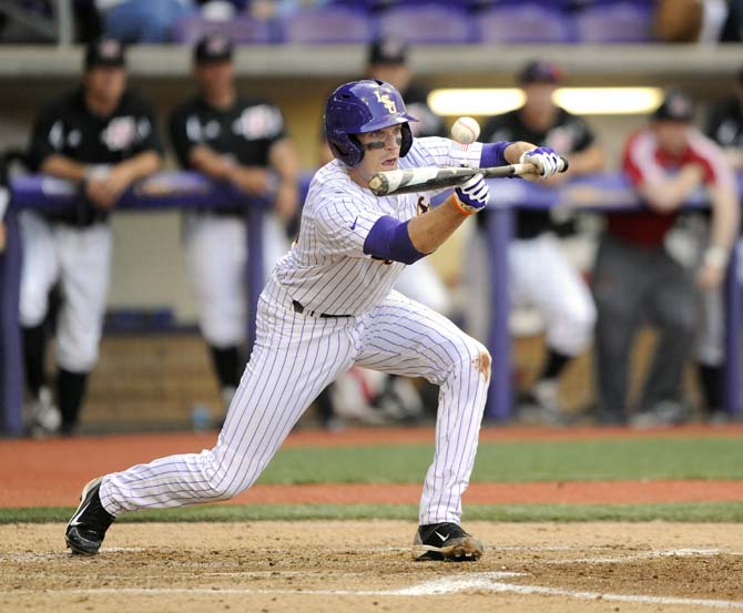 LSU junior infielder Conner Hale (20) lays a bunt Tuesday, March 11, 2014 during the Tigers' 5-3 win against Nicholls State in Alex Box Staidum.