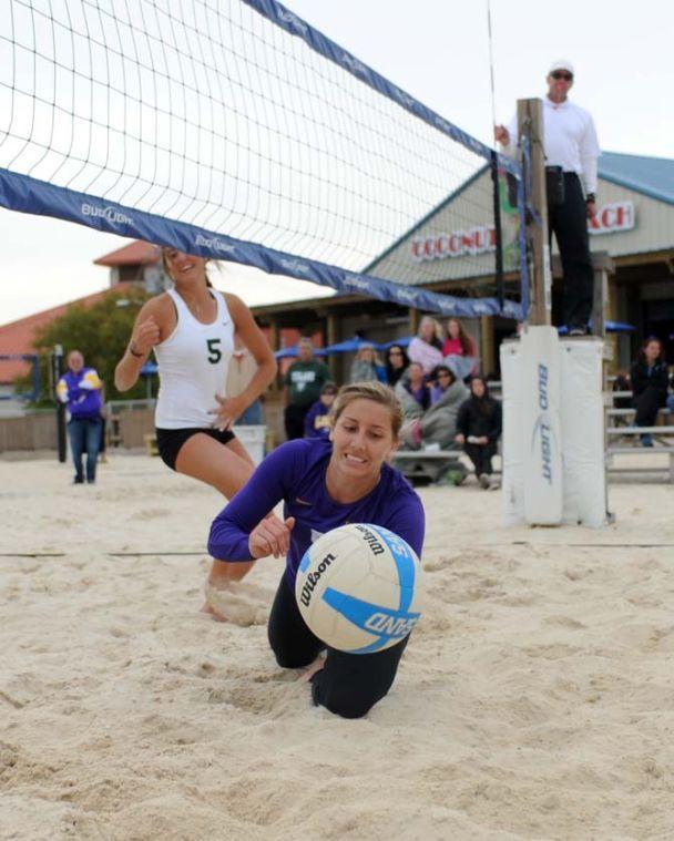 LSU sophomore sand volleyball player Katie Lindelow (5) dives for the ball Wednesday, March 26, 2014, during the Tigers' 3-2 lost against Tulane at Coconut Beach Sand Volleyball Complex.
