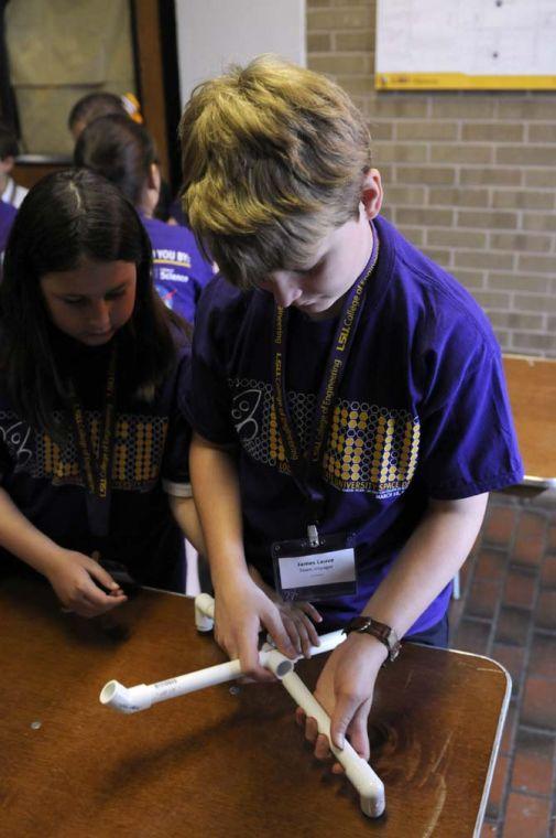 James Louvre, a St. Aloysius Academy student, builds a rocket launcher Friday, March 28, 2014, during Space Day at Patrick F. Taylor Hall.