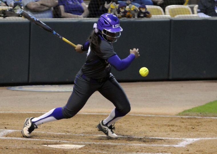 LSU sophomore infielder and pitcher Bianka Bell (27) hits the ball during during the Lady Tigers' 3-2 victory against the Gators on March 15, 2014 at Tiger Park.