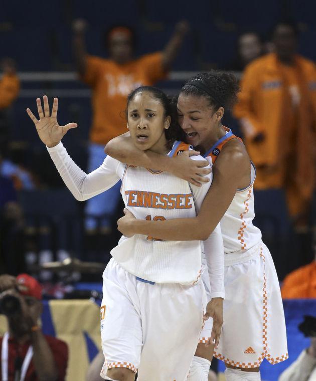 Tennessee guard Meighan Simmons, left, celebrate with guard Andraya Carter (14) after scoring the go-ahead basket late in the second half in an NCAA college basketball game in the quarterfinals of the Southeastern Conference women's tournament, Friday, March 7, 2014, in Duluth, Ga. Tennessee won 77-65. (AP Photo/Jason Getz)