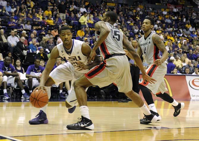 LSU freshman forward Jordan Mickey (25) dribbles around defenders Saturday, March 8, 2014 during the Tigers' 61-69 loss to Georgia in the PMAC.