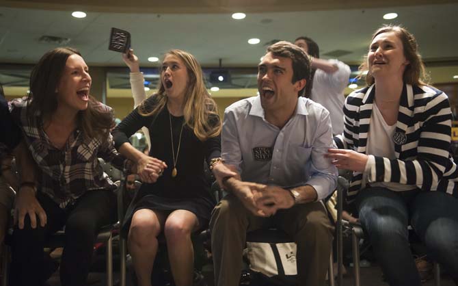 Newly-elected Student Government President Clay Tufts (middle right) and Vice President Taylor Lambert (middle left) react to hearing election results Wednesday, March 25, 2014, in the Student Union.