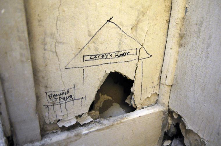 Crumbling drywall near an artist's workspace in the Studio Arts building. Someone labeled the hole "Leroy's House" in jest.