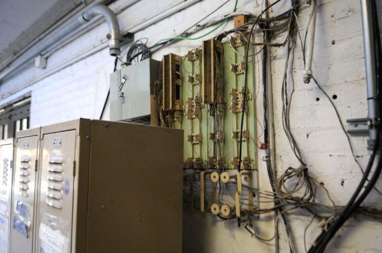 Wiring is exposed in close proximity to water leaks in the hallway of the Studio Arts Building.