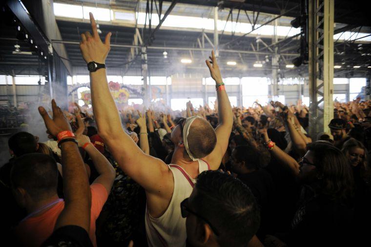 Festival-goers raise their hands in anticipation of a drop at Paper Diamond's set during Buku Music + Art Project on Friday, March 21, 2014 at Mardi Gras World in New Orleans.