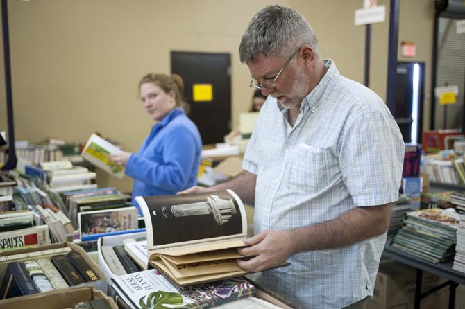 Boyd, a shopper at the LSU Libraries Friends of the Libraries Annual Book Bazaar, looks at a book Thursday, March 20, 2014 in the 4-H mini barn.