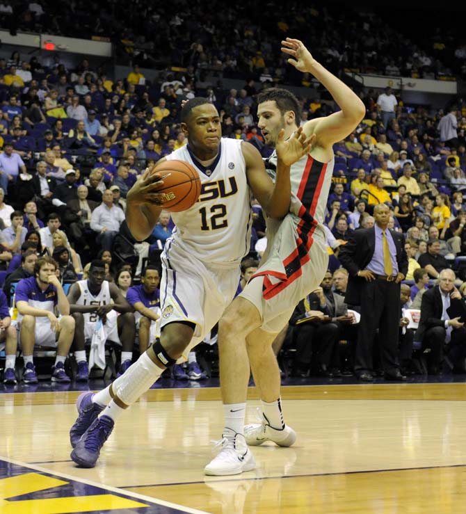 LSU freshman forward Jarell Martin (12) dribbles around a Georgia defender Saturday, March 8, 2014 during the Tigers' 61-69 loss to the Bulldogs in the PMAC.