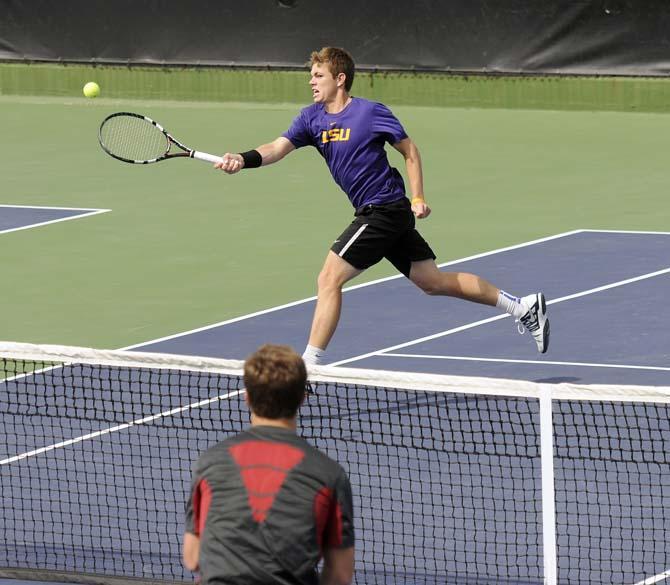 LSU junior Chris Simpson returns the ball Friday, March 7, 2014 during a tennis match against Alabama in W.T. "Dub" Robinson Stadium.