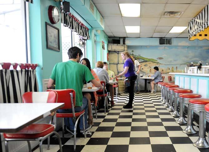 Waitress Dawn Simonson serves a table Sunday, March 23, 2014 at Louie's Café.