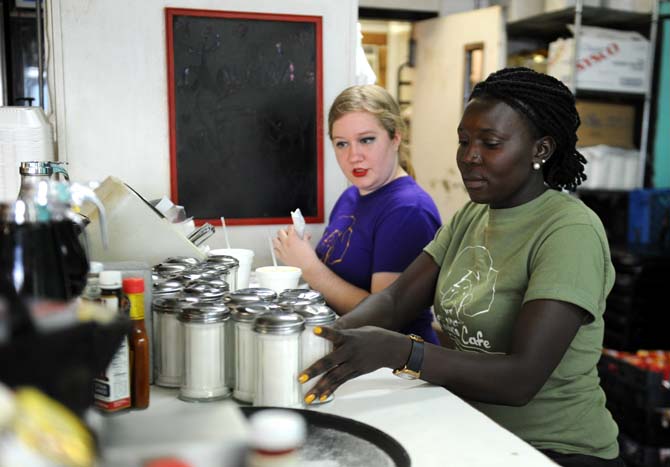 Waitress Dawn Simonson (left) sits with co-worker Jessica Poni (right) on Sunday, March 23, 2014 at Louie's Café.