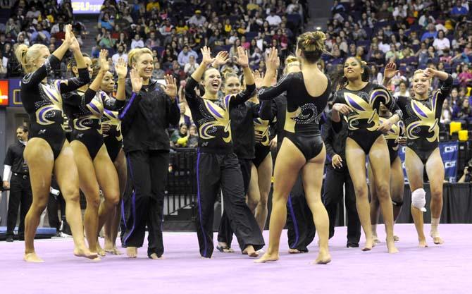 LSU junior Jessie Jordan celebrates with the LSU Gymnastics team Friday, March 14, 2014 during the Lady Tigers' 197.800-195.000 victory against Kentucky in the PMAC.