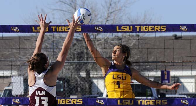 LSU senior Meghan Mannari (4) spikes the ball through ULM graduate student Zuzana Markova (13) on Tuesday, March 18, 2014, during the Tigers' 2-3 loss to the Warhawks at Mango's Outdoor Volleyball.